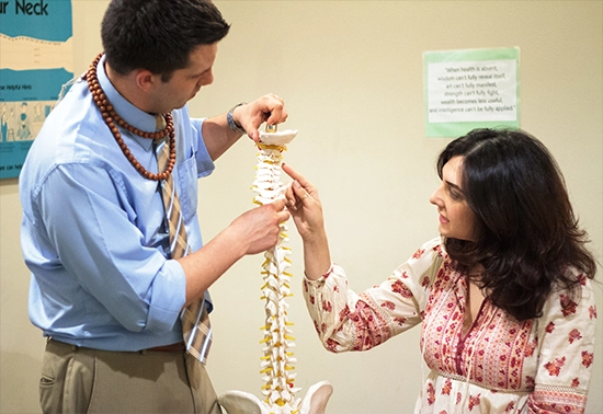 Chiropractor Burbank CA Brian Pazera With Patient Consultation